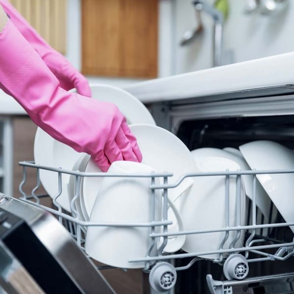 woman using dishwasher to save energy in winter