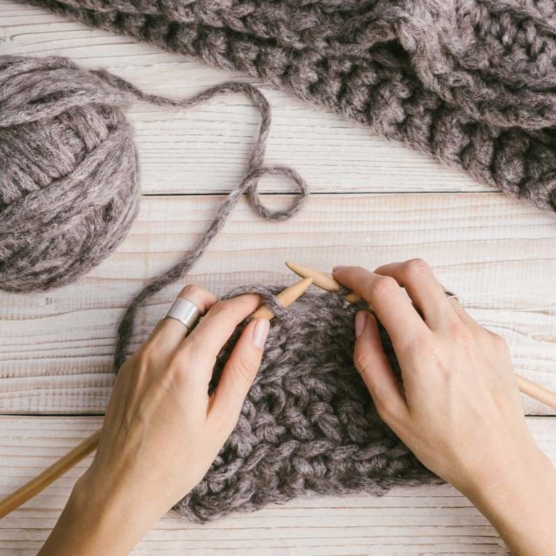 woman knitting an inexpensive wedding gift