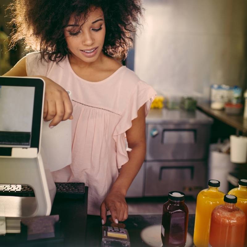 young woman paying for coffee at counter