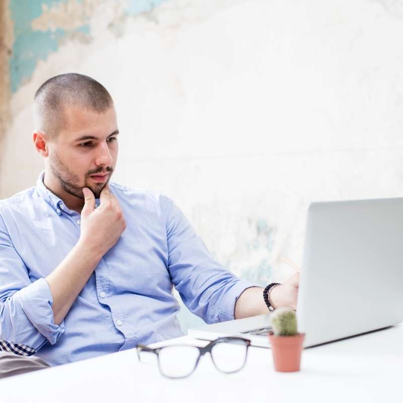 furloughed worker looking at laptop during coronavirus outbreak 