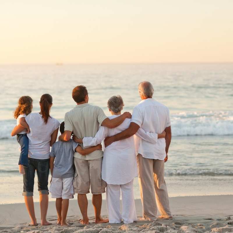 family standing on beach