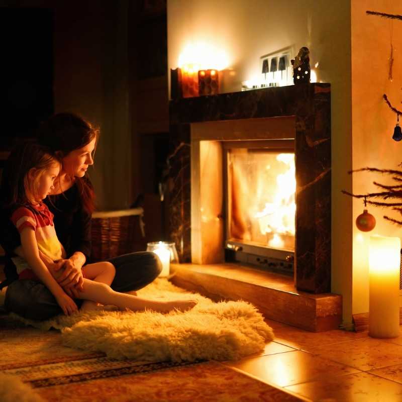 Mother and daughter in front of energy saving fireplace