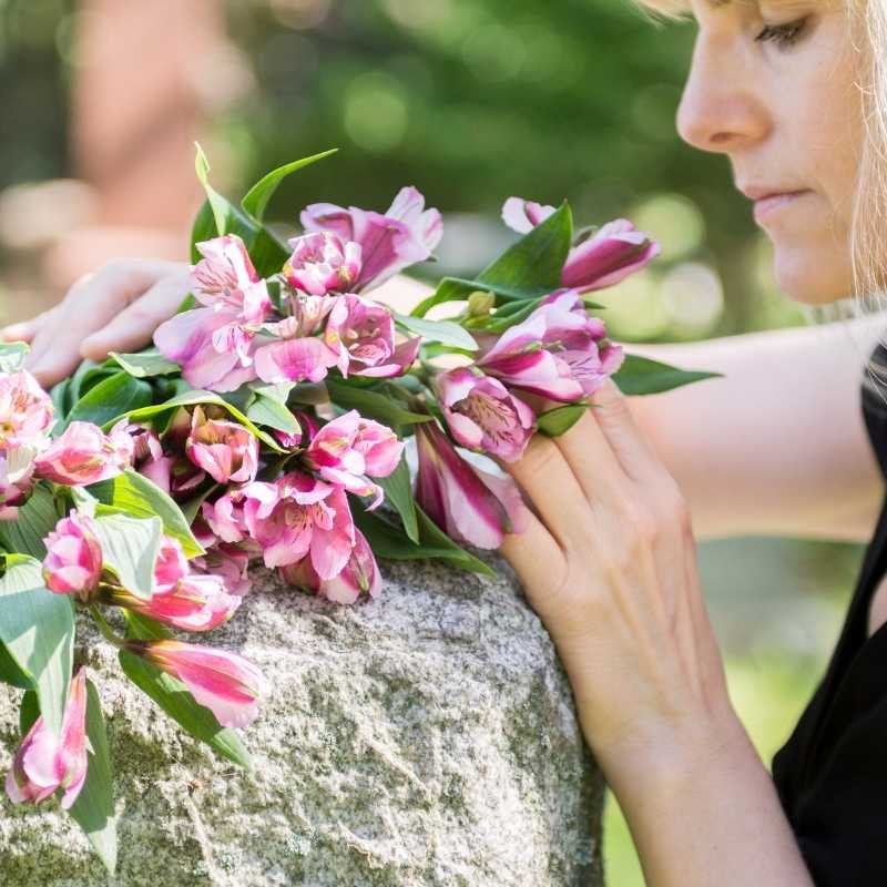 woman mourning death of parent at gravesite