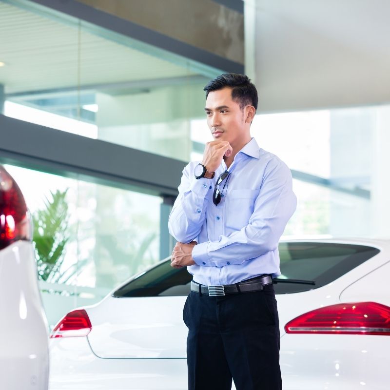 man figuring out how much car he can afford at dealership