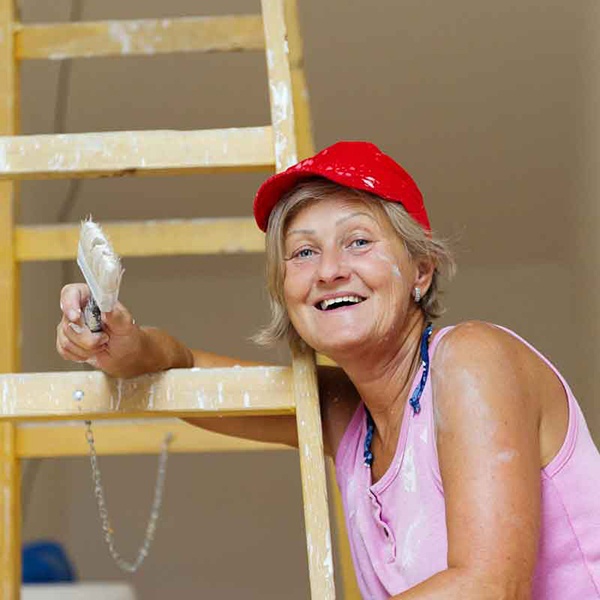 Paint flecked woman on ladder painting.jpg