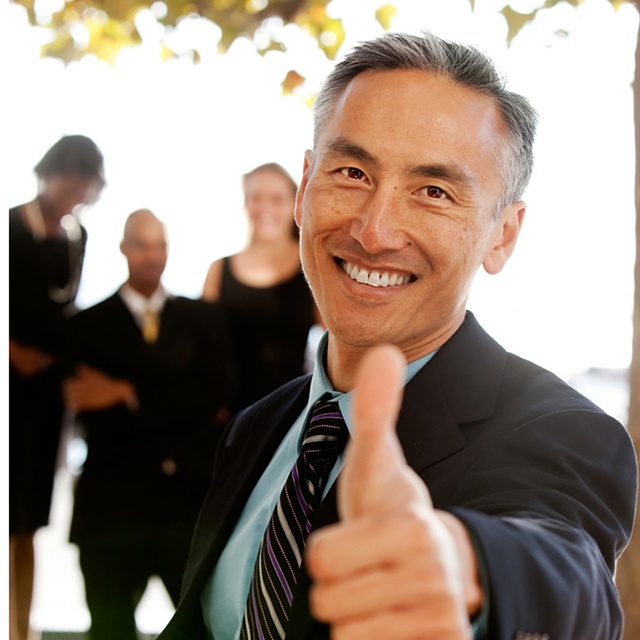 man giving thumbs up for credit union benefits at work