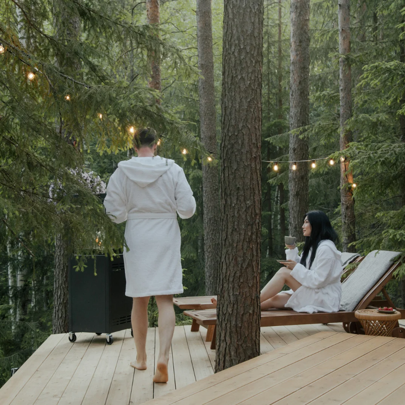 couple relaxing on treetop deck on investment property they own