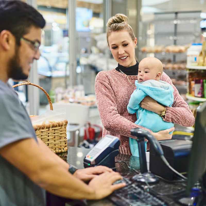 woman-with-baby-at-cash-register